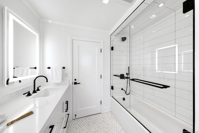 full bath with enclosed tub / shower combo, crown molding, and vanity