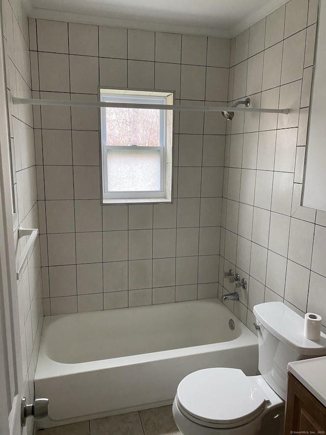 bathroom featuring toilet, shower / bathtub combination, vanity, and tile patterned floors