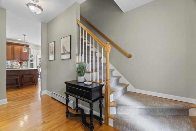 3 Spencer Ct, Clinton, CT 06413 - staircase with wood finished floors, baseboards, and a baseboard radiator