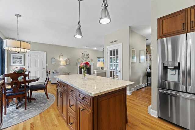 3 Spencer Ct, Clinton, CT 06413 - kitchen featuring stainless steel refrigerator with ice dispenser, baseboard heating, light wood-style flooring, a kitchen island, and decorative light fixtures