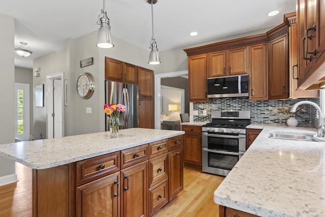 3 Spencer Ct, Clinton, CT 06413 - kitchen featuring stainless steel appliances, a sink, light wood-style floors, decorative backsplash, and pendant lighting