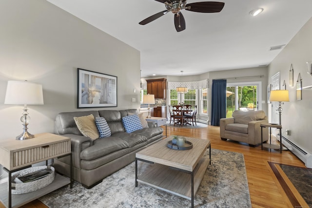 3 Spencer Ct, Clinton, CT 06413 - living room featuring a baseboard heating unit, light wood-type flooring, and a ceiling fan