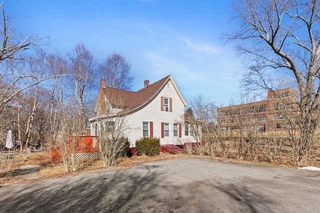 view of property exterior with a chimney