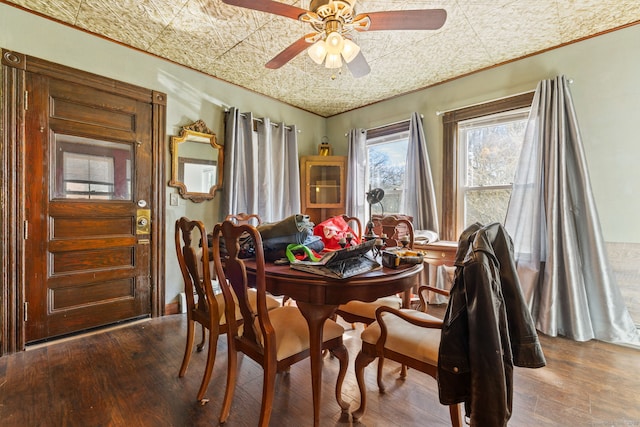 dining space with an ornate ceiling, dark wood-style flooring, and ceiling fan