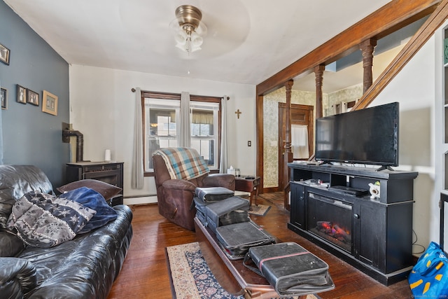 living room with a baseboard radiator, ceiling fan, and wood finished floors