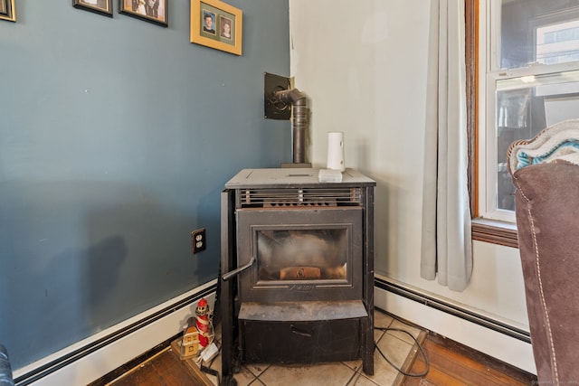 interior details featuring a wood stove and a baseboard heating unit