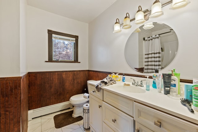 bathroom featuring a baseboard radiator, toilet, wainscoting, wooden walls, and vanity