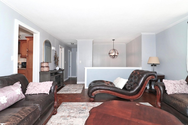 living room featuring baseboards, crown molding, and an inviting chandelier