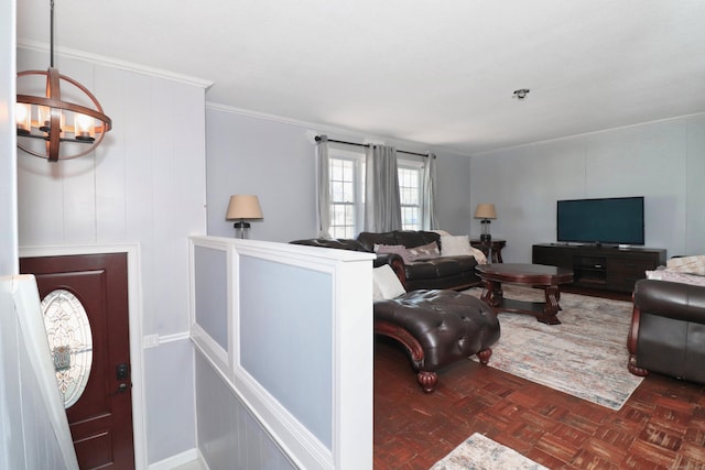 living area featuring ornamental molding and a chandelier