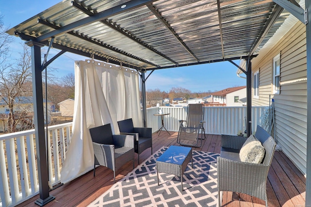 wooden deck with an outdoor hangout area and a pergola