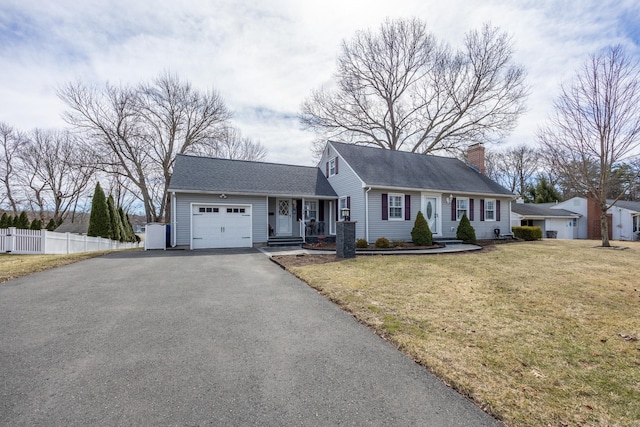 view of front of house featuring a front lawn, driveway, fence, an attached garage, and a chimney