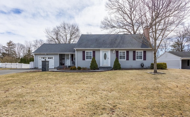 new england style home with a shingled roof, fence, aphalt driveway, a front yard, and an attached garage