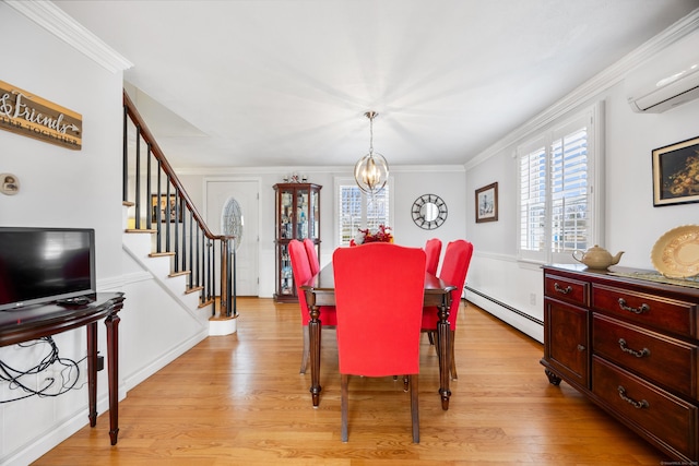 dining area with light wood finished floors, stairway, a wall mounted air conditioner, ornamental molding, and baseboard heating