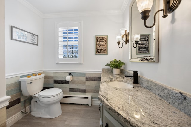 bathroom featuring baseboard heating, ornamental molding, wainscoting, and toilet