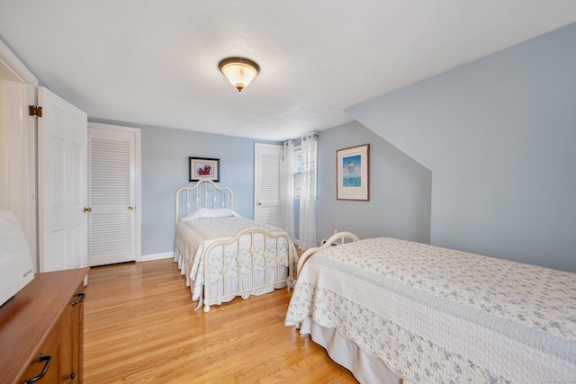 bedroom with baseboards and light wood-type flooring