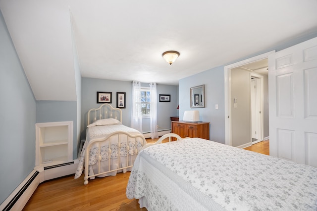 bedroom featuring a baseboard radiator and light wood finished floors