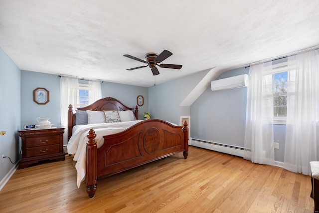 bedroom featuring a wall mounted air conditioner, light wood-type flooring, a ceiling fan, a baseboard radiator, and baseboards