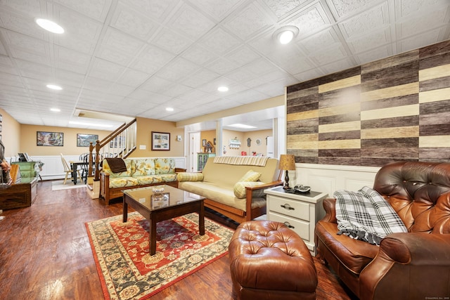 living room featuring stairway, recessed lighting, wood finished floors, and wainscoting