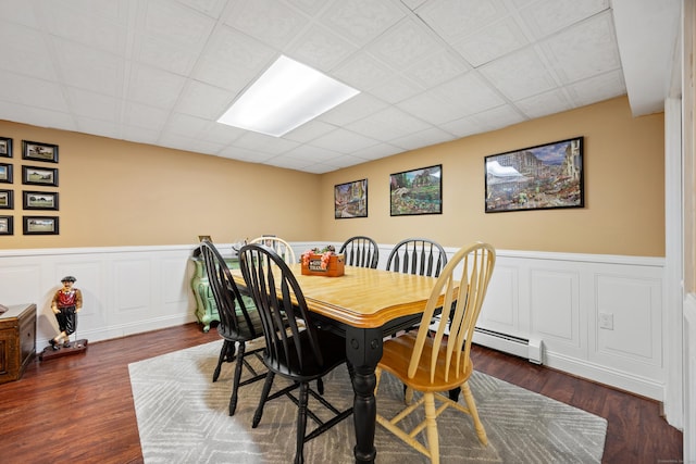 dining room featuring a wainscoted wall, a paneled ceiling, and wood finished floors