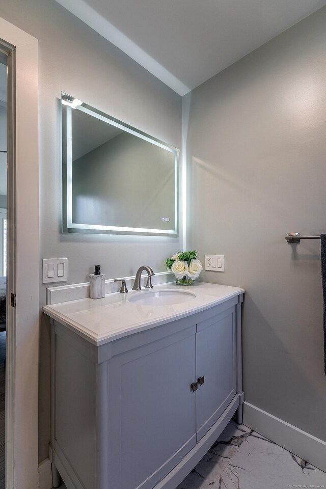 34 Indian Hill Rd, New Fairfield, CT 06812 - bathroom featuring vanity, baseboards, and marble finish floor