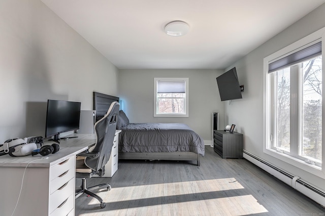 34 Indian Hill Rd, New Fairfield, CT 06812 - bedroom featuring a baseboard radiator, multiple windows, and light wood-style floors