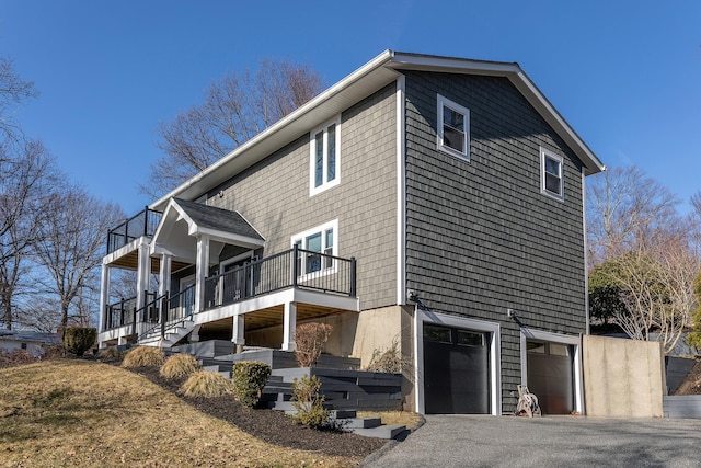 34 Indian Hill Rd, New Fairfield, CT 06812 - view of side of home with a garage, a balcony, and aphalt driveway