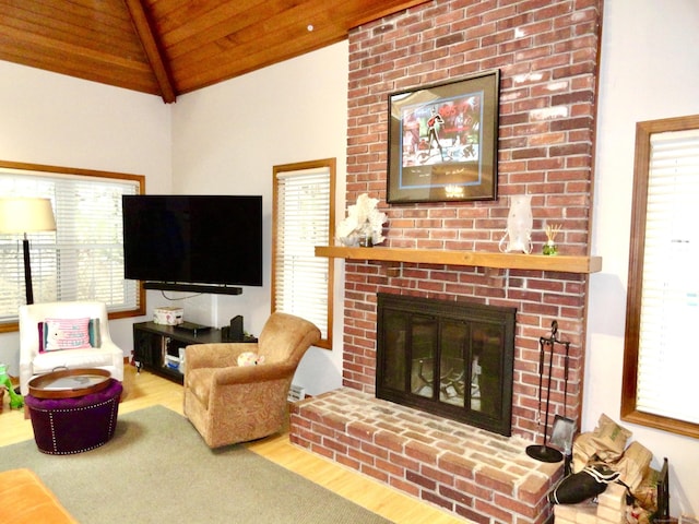 living room featuring lofted ceiling, a healthy amount of sunlight, wood ceiling, and wood finished floors