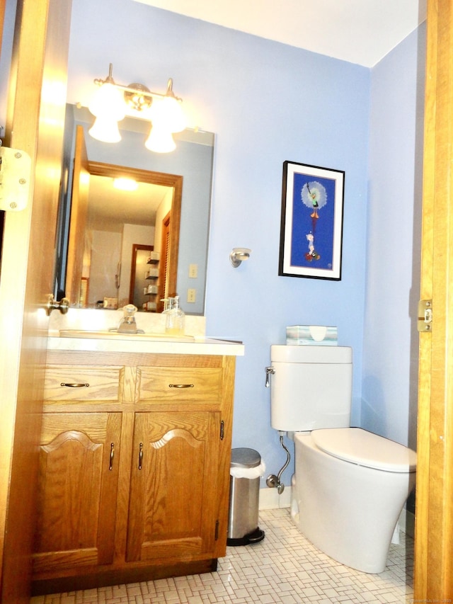 bathroom featuring vanity, toilet, and tile patterned floors