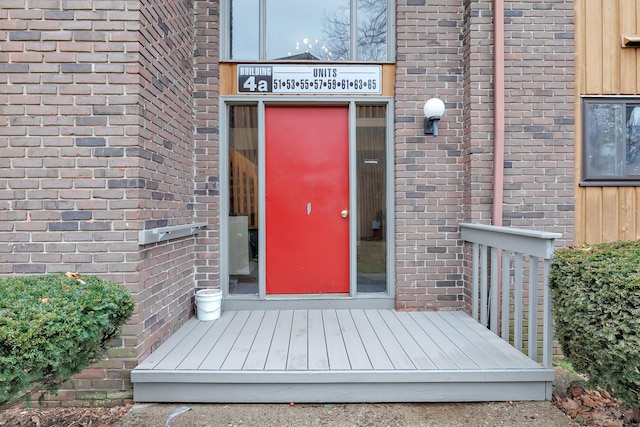 entrance to property featuring brick siding