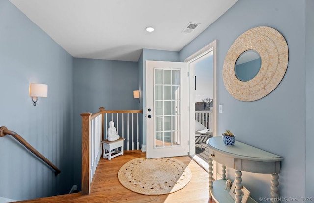 doorway featuring recessed lighting, visible vents, and wood finished floors