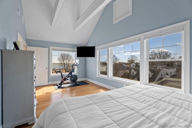 bedroom featuring high vaulted ceiling, baseboards, wood finished floors, and beamed ceiling