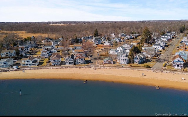 drone / aerial view featuring a water view and a residential view