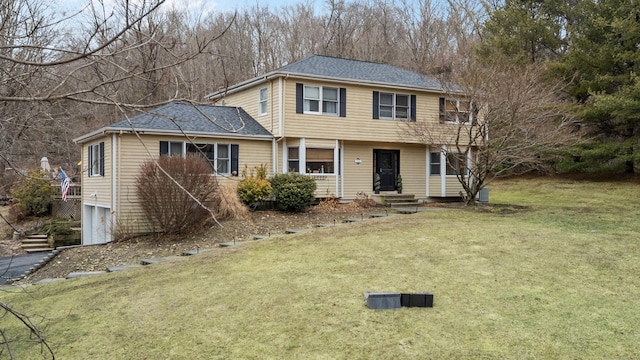 view of front of house featuring a front yard and an attached garage