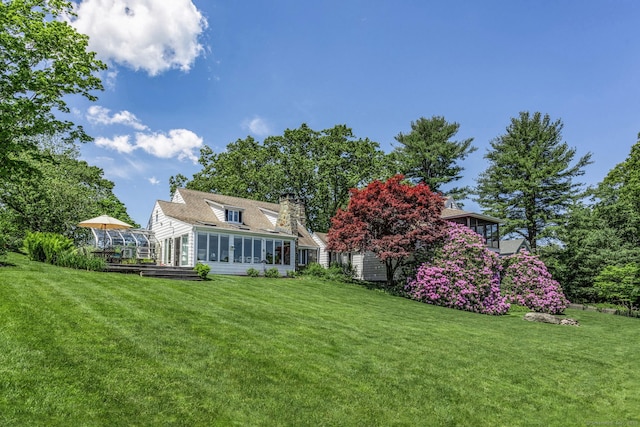 view of yard featuring a sunroom