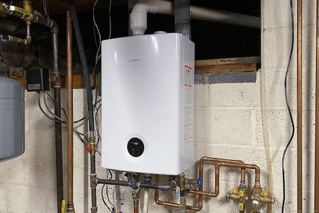 utility room featuring water heater