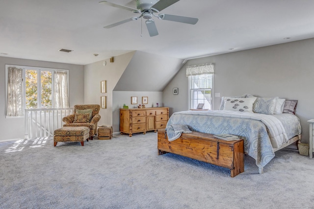 bedroom featuring ceiling fan, carpet floors, vaulted ceiling, and visible vents