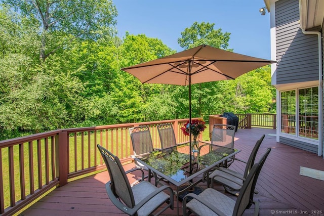 wooden deck featuring outdoor dining area