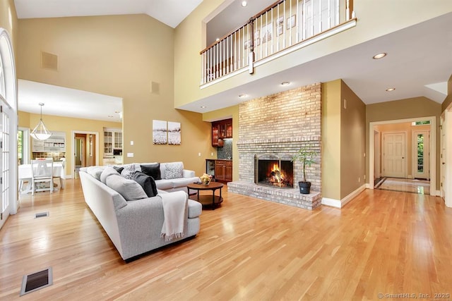 living room featuring light wood-type flooring and visible vents