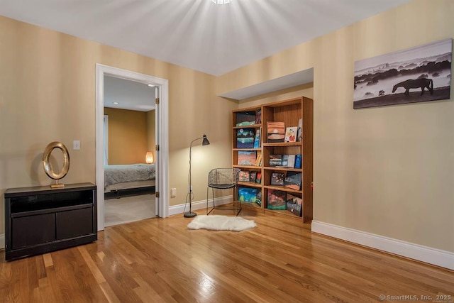 interior space featuring baseboards and wood finished floors