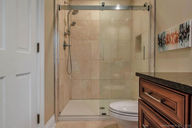 bathroom featuring a stall shower, vanity, and toilet