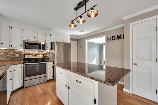 kitchen with stainless steel appliances, light wood-type flooring, visible vents, and white cabinets