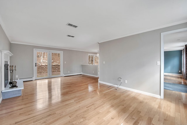 unfurnished living room featuring visible vents, baseboards, a glass covered fireplace, light wood-style flooring, and a baseboard heating unit