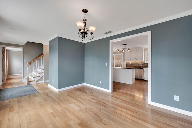 unfurnished dining area featuring light wood-style floors, stairway, visible vents, and a notable chandelier