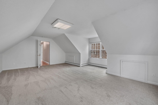 bonus room with carpet, vaulted ceiling, baseboards, and a baseboard radiator