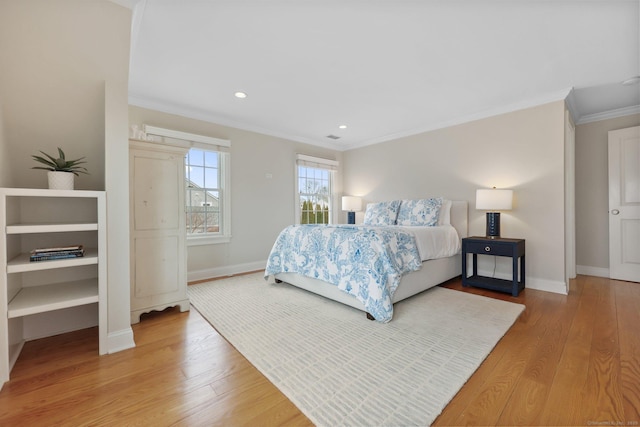 bedroom featuring light wood-style flooring, baseboards, and ornamental molding