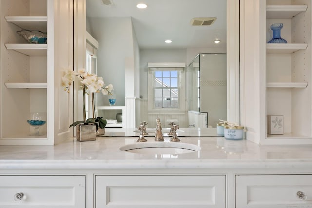 bar with built in features, recessed lighting, visible vents, and a sink