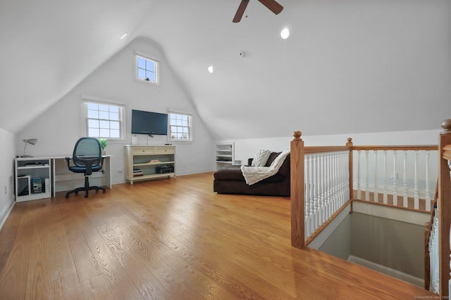 office space featuring baseboards, vaulted ceiling, a ceiling fan, and hardwood / wood-style flooring