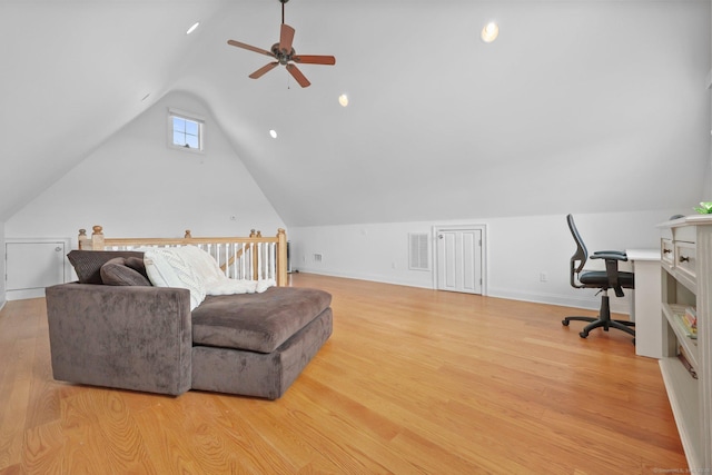 office featuring visible vents, a ceiling fan, baseboards, light wood finished floors, and lofted ceiling