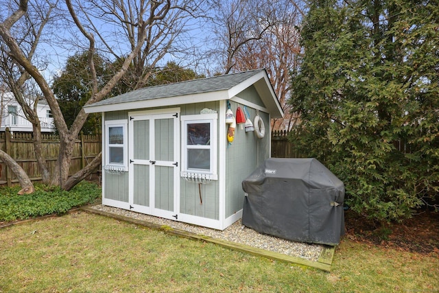 view of shed featuring fence