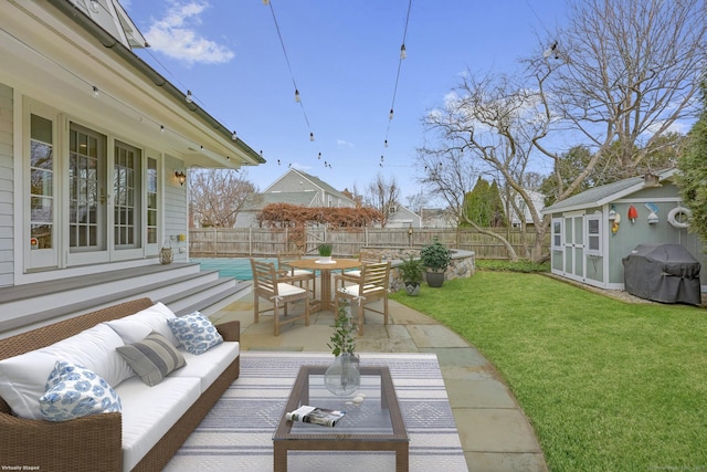 view of patio with an outbuilding, a shed, outdoor dining area, french doors, and outdoor lounge area